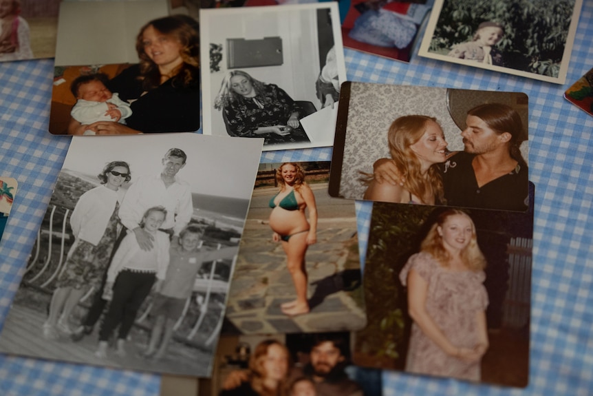 A collection of photographs of a lady's life including pregnancy photos and family photos, all laig out on top of a table