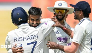 India's Manav Suthar is congratulated by team-mates