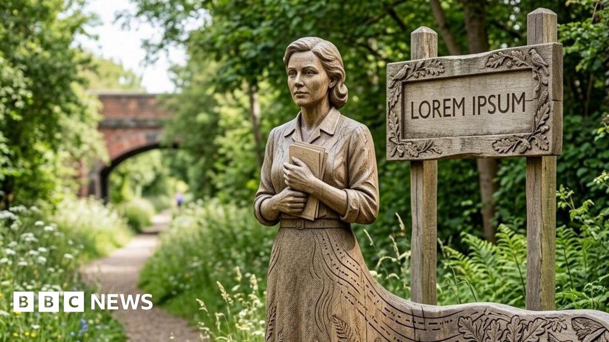 A wooden sculpture of a woman holding a book, her body merging with a bench by the side of a path running under an old railway bridge in the countryside