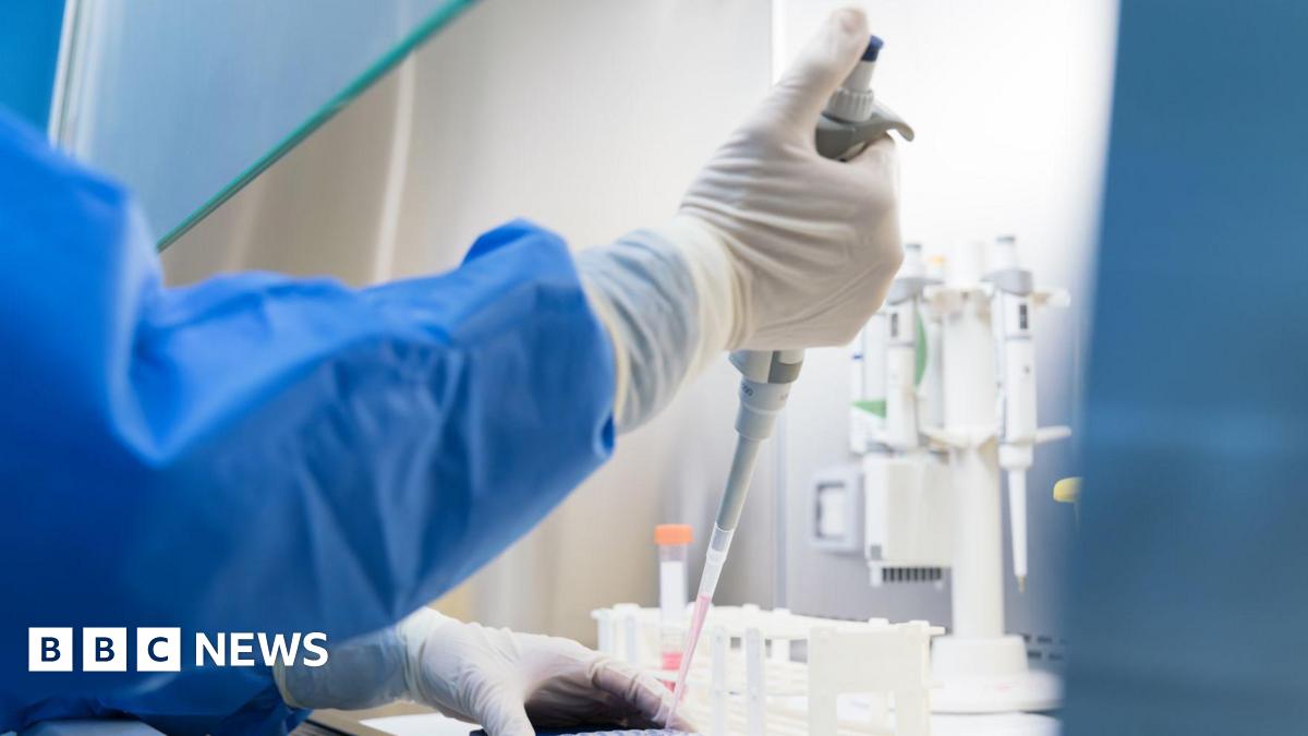 Scientists conduct scientific experiments in the biosafety cabinet of the laboratory - stock photo.