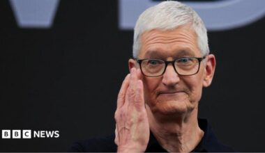 Apple CEO Tim Cook touches his hand to his face while on stage during Apple's annual Worldwide Developers Conference in Cupertino, California, U.S.