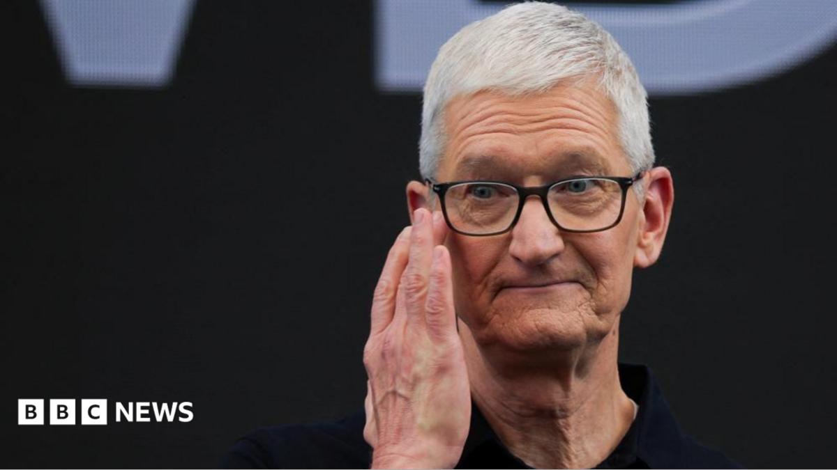 Apple CEO Tim Cook touches his hand to his face while on stage during Apple's annual Worldwide Developers Conference in Cupertino, California, U.S.
