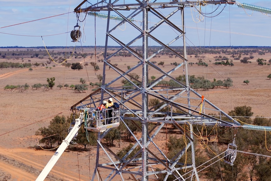 Men working to construct a large transmission line tower in southern NSW