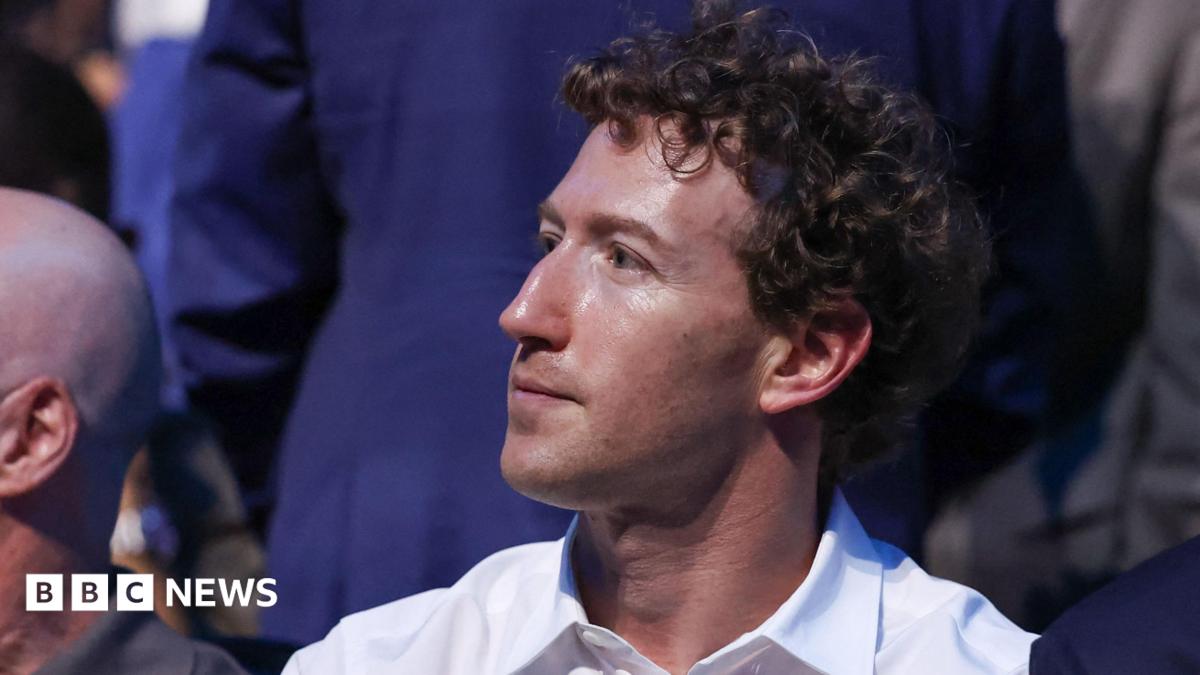 Mark Zuckerberg, wearing a white collared shirt while sitting in a crowd at the recent UFC event at the White House.