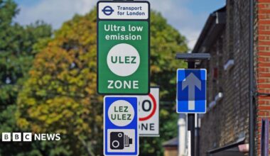 Green and blue Ulez sign with camera