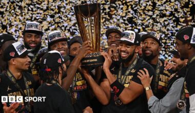 New York Knicks players holding the NBA Championship trophy