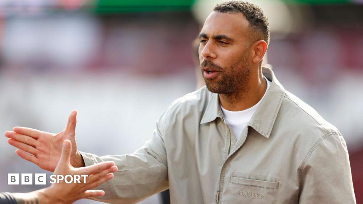 Anton Ferdinand shaking hands with a person off camera