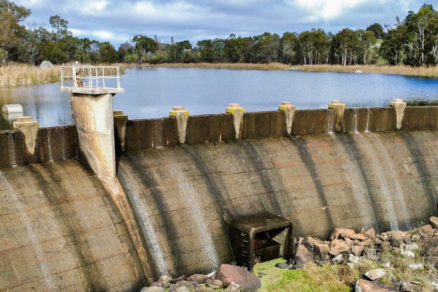 The wall of an overflowing dam