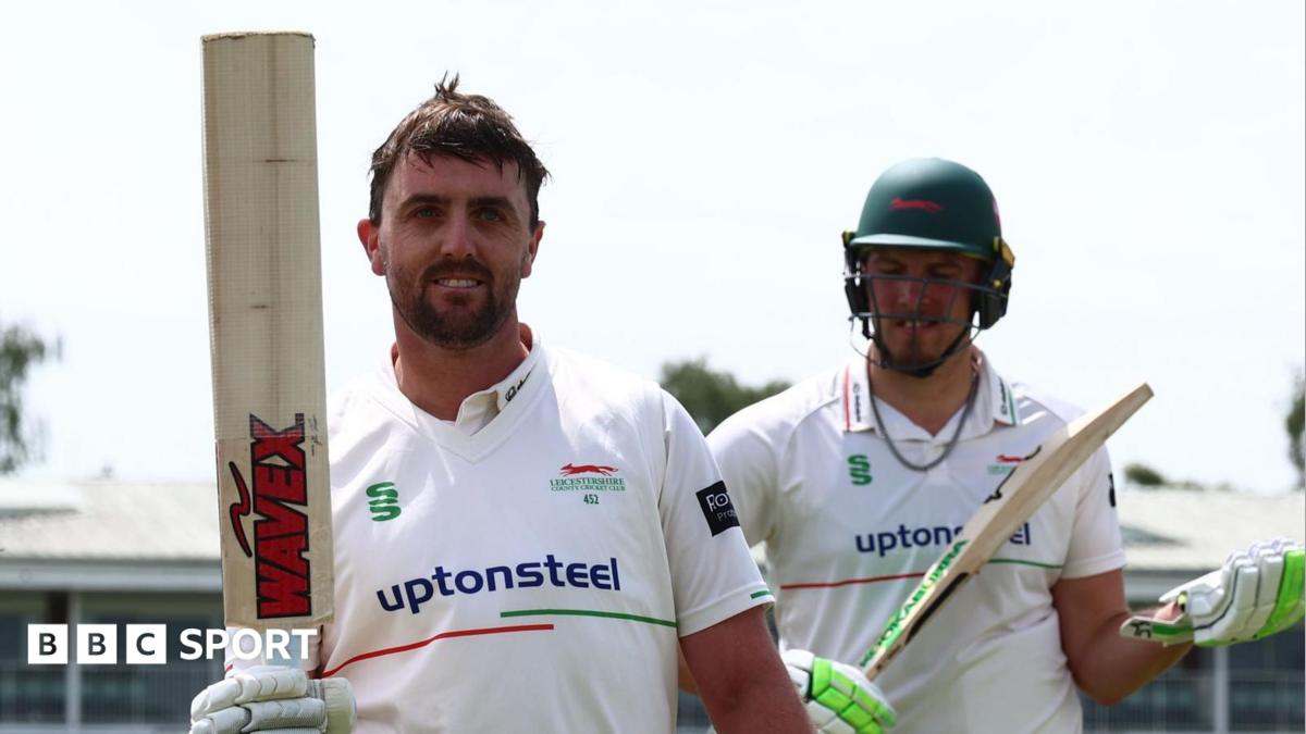 Leicestershire's Lewis Hill hold his bat up as he leaves the field