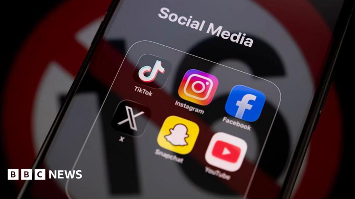 TikTok, Instagram, Facebook, X, Snapchat and YouTube apps displayed on an iPhone screen under a "social media" tab, with an icon used to show under-16s banned reflected across it.