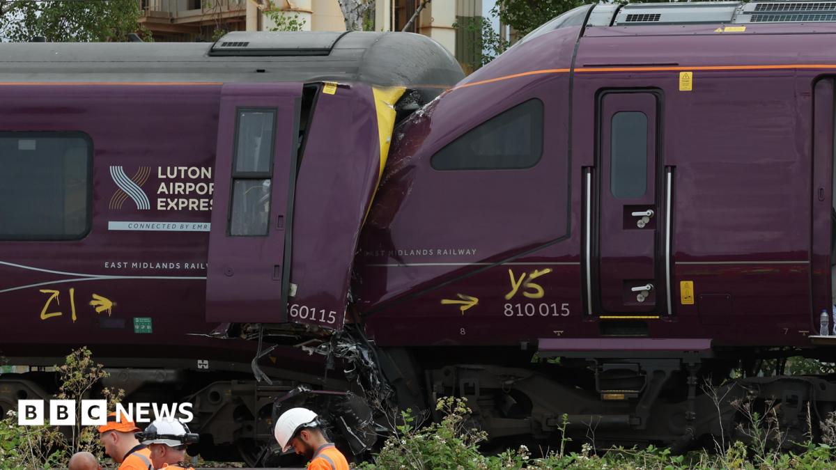 The ends of two damaged purple trains which have crashed together.