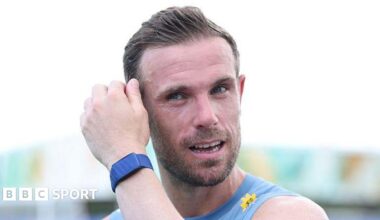 Jordan Henderson mops his brow during an England training session