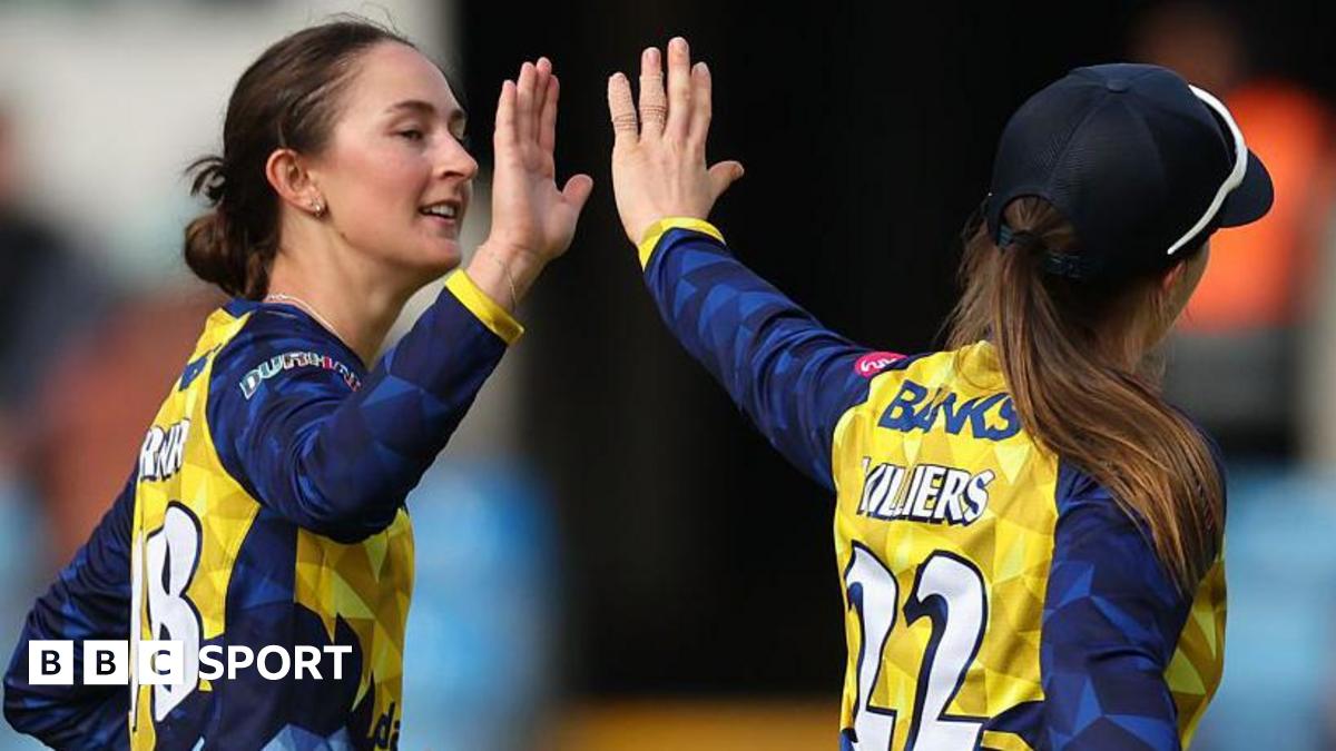 Heather Graham hets a high five from Durham skipper Mady Villers.