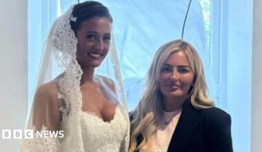 Venezuela Fury in a wedding dress stood next to Lynsey Austin. She is wearing a black jacket and a pink top underneath it.