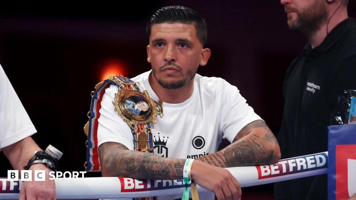 Lee Selby wears a white t-shirt with a Lonsdale belt over his shoulder, leaning on the ropes from the ring apron ahead of a Joe Cordina fight in Cardiff