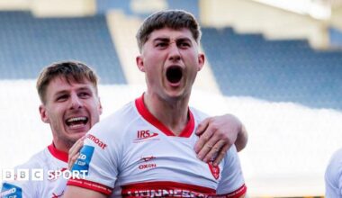 Hull Kingston Rovers forward Tom Whitehead shouts in celebration after scoring a try against Huddersfield Giants, with grinning team-mate Tom Davies behind him and grabbing his shoulder.
