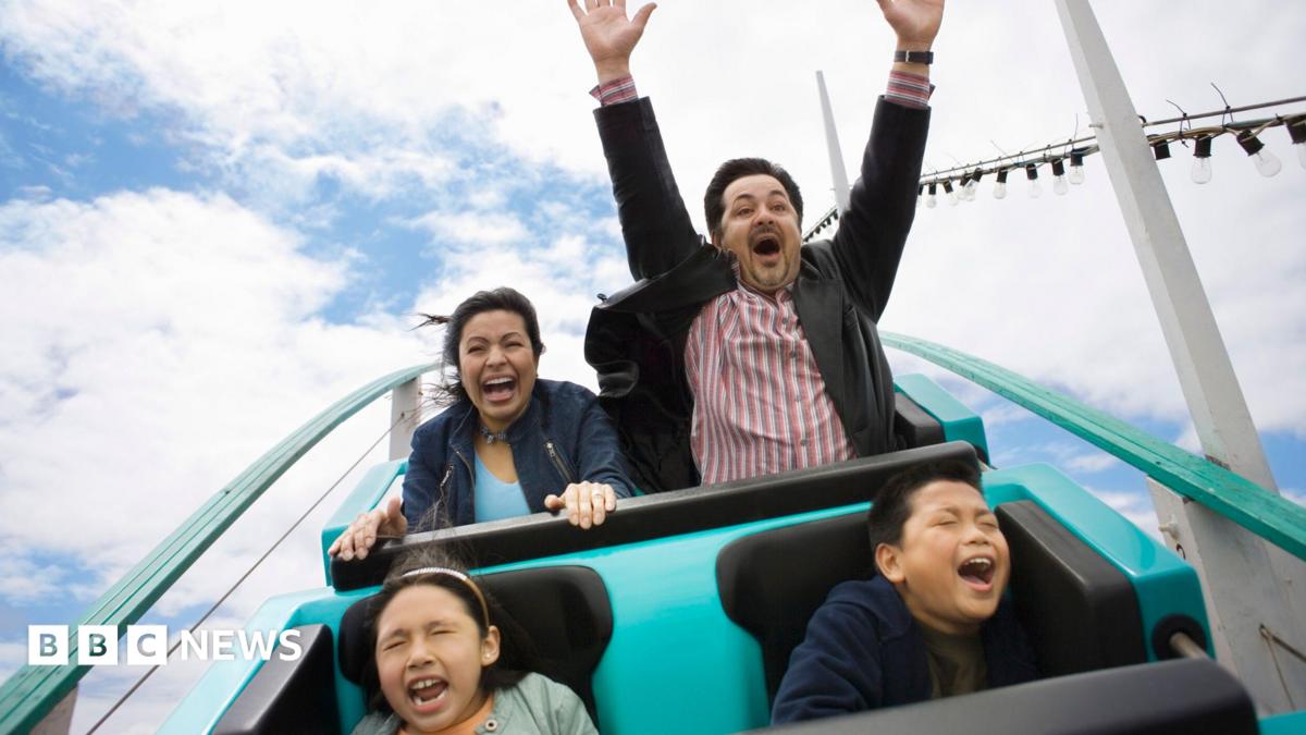 A stock image of a family enjoying a rollercoaster.