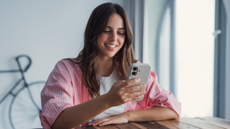 A young person looking at a phone screen