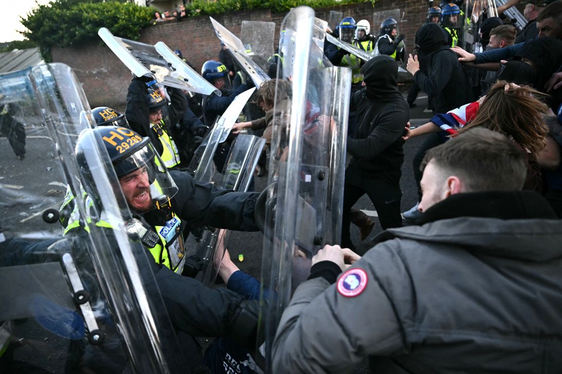 Demonstrators surge at police officers near Portswood Police Station in Southampton on Tuesday.