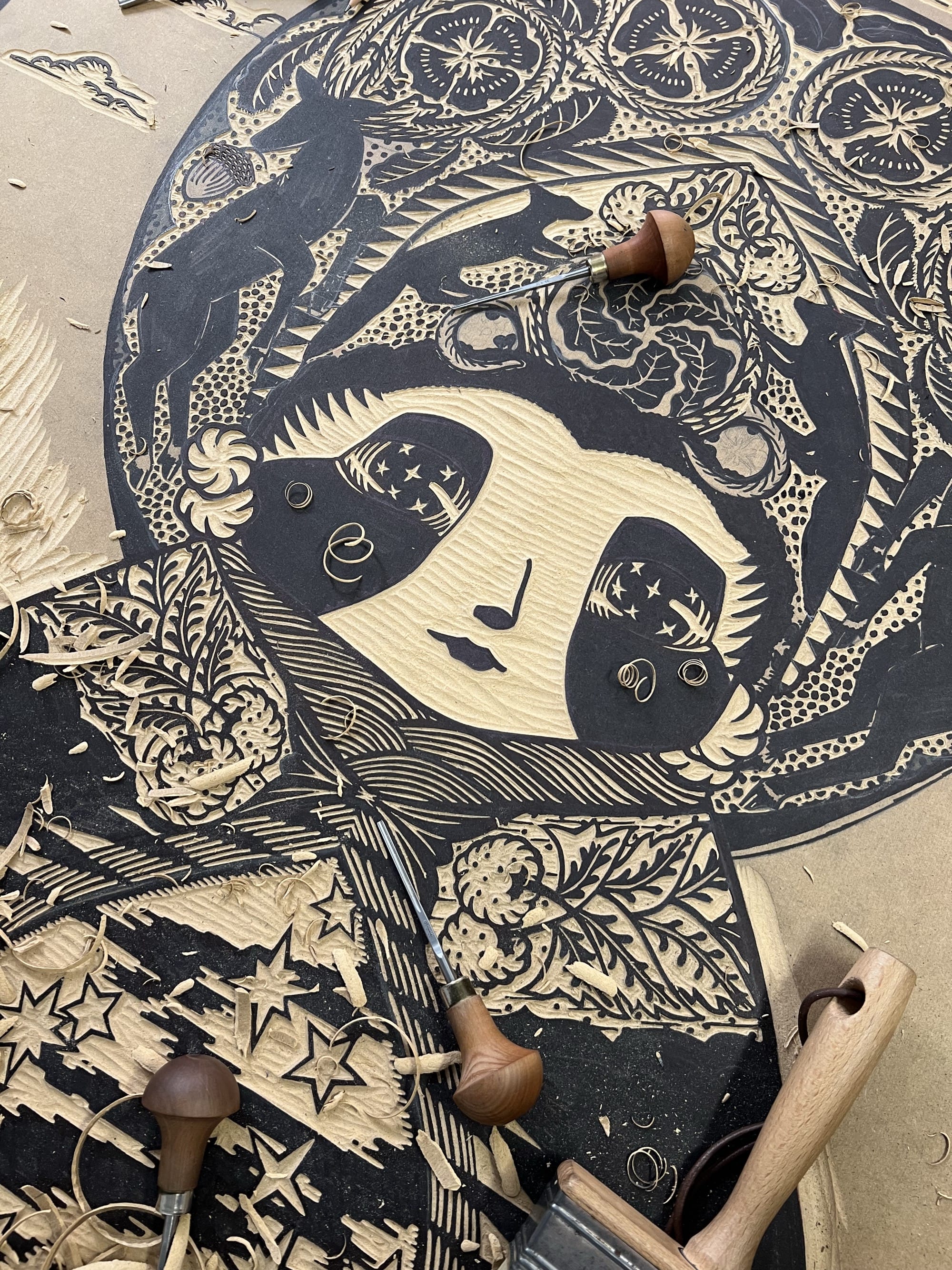 a detail of the face and garments of a woodblock print of a spiritual figure