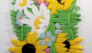 an artwork of cartoonish sculptural flowers made of poylurethane that are squished between two panels of Plexiglas