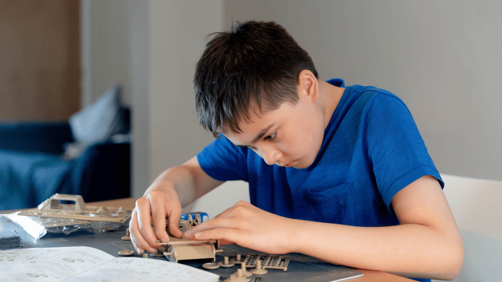 young boy building a model as a hobby and protecting his mental health