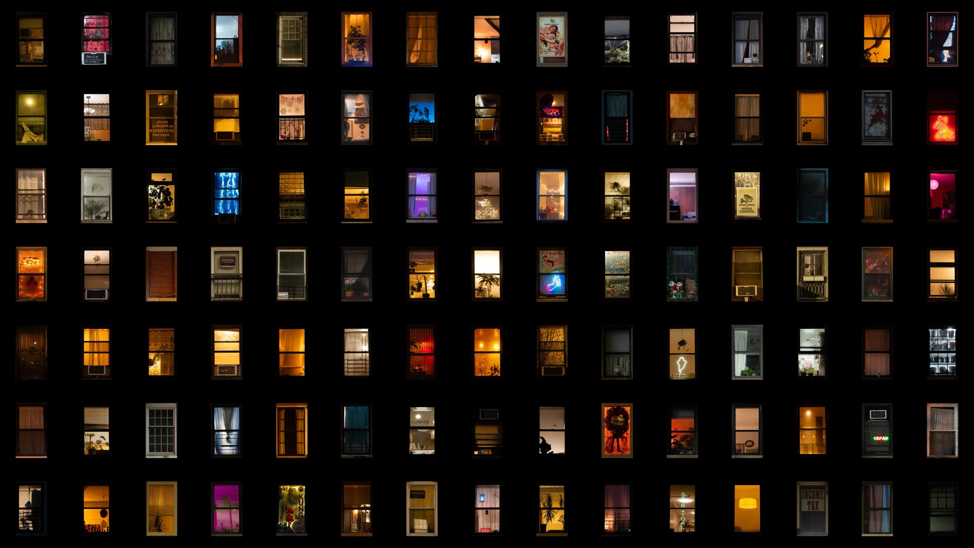 a composite grid of nighttime photographs of windows in New York City