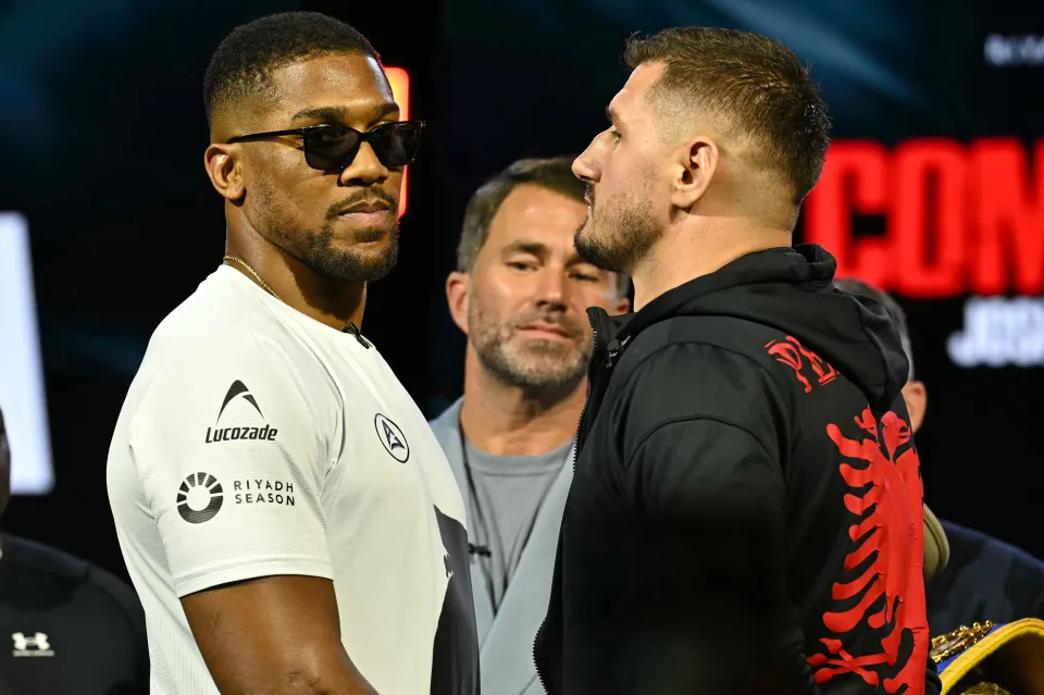 Albania's Kristian Prenga (R) and Britain's Anthony Joshua (L) pose with promoter Eddie Hearn (C) at a press conference in London on June 1, 2026, ahead of their boxing match in Saudi Arabia in July.