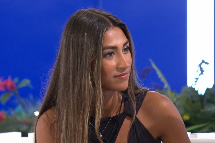 Love Island S13 Priya Jaswal sat down at the Love Island firepit looking across at someone.