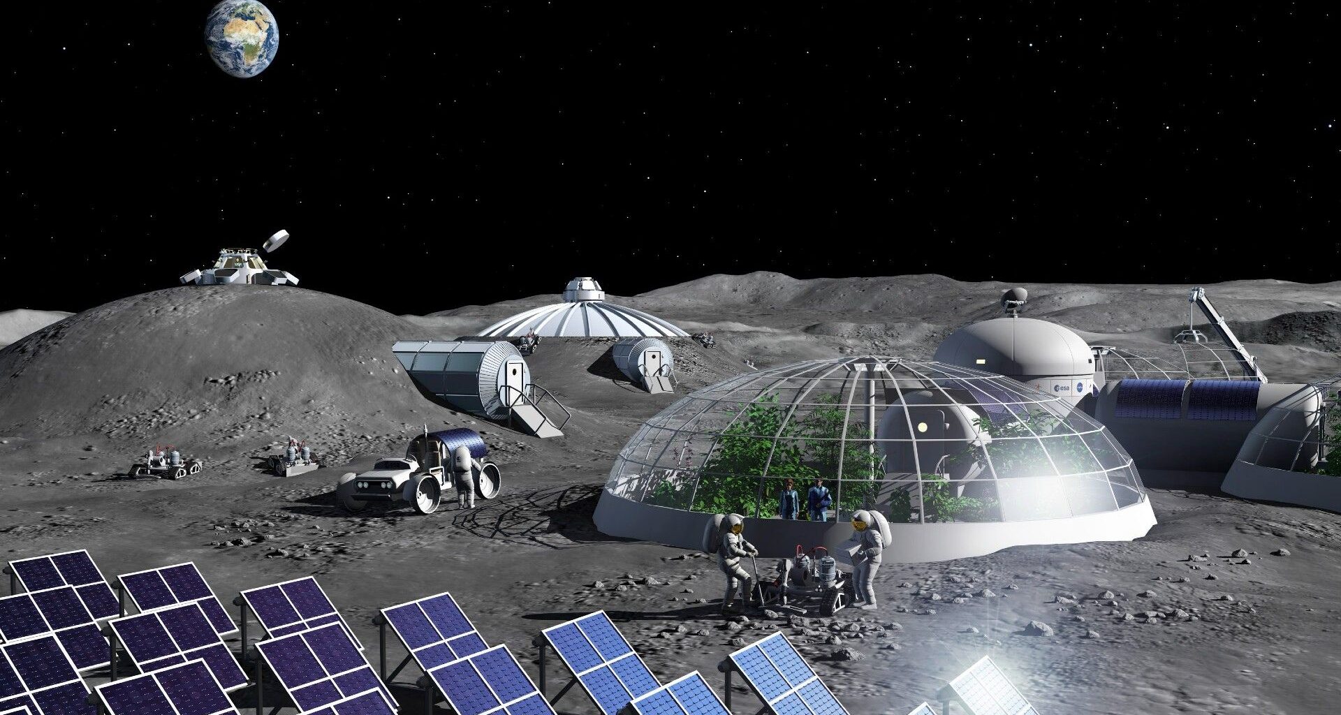 astronauts in bulky space suits walk on a dusty grey surface among glass-domed habitats under a black starless sky