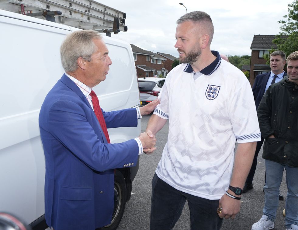 Nigel Farage and Robert Kenyon - who is wearing an England football shirt