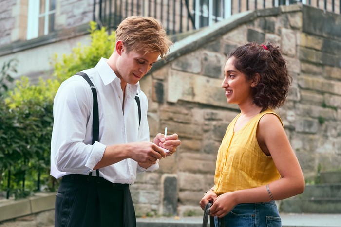 One Day Dexter writing his phone number on a piece of paper for Emma in the middle of the street