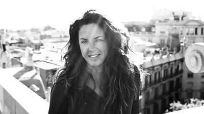 Black and white photo of second director Claudia Llosa stood on a rooftop balcony. 