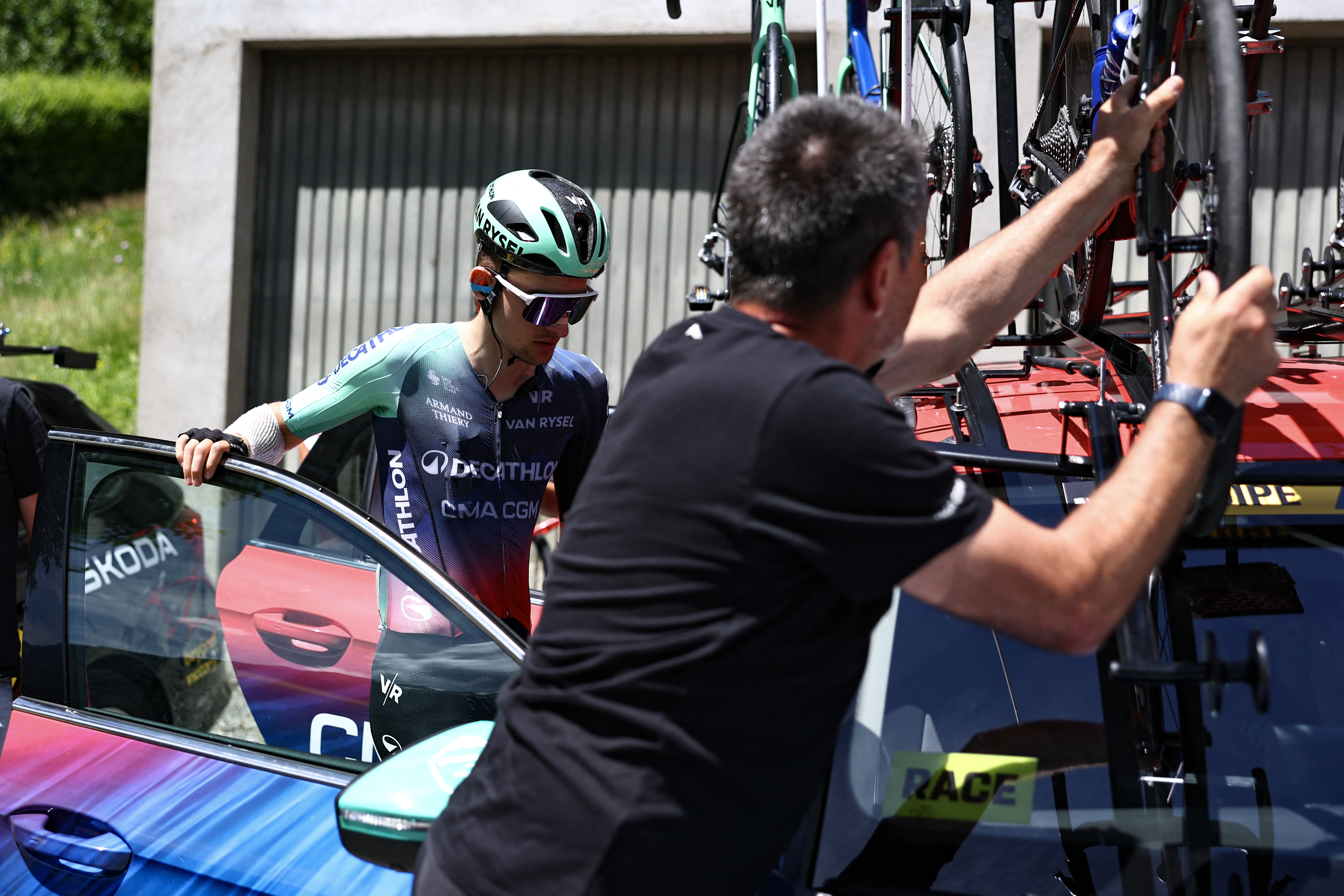 Decathlon CMA CGM Team's French rider Paul Seixas enters his team vehicle as he withdraws from the race on the 8th and final stage of the Tour Auvergne-Rhone-Alpes cycling race (formerly known as the Criterium du Dauphine), 120,1km between Beaufort and Plateau de Solaison, in the French Alps on June 14, 2026. (Photo by Anne-Christine POUJOULAT / AFP)