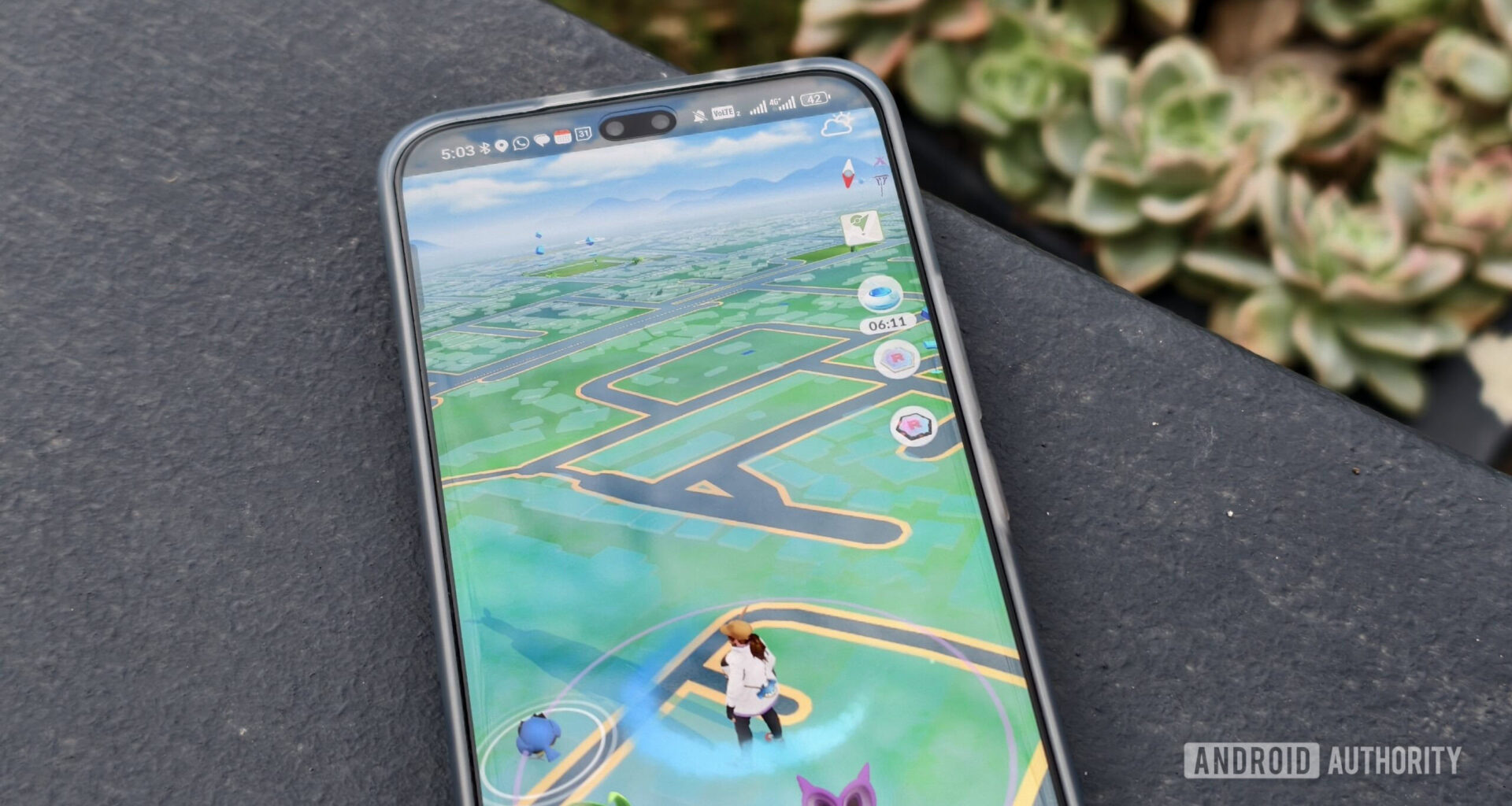 pokemon go on a smartphone on a concrete wall
