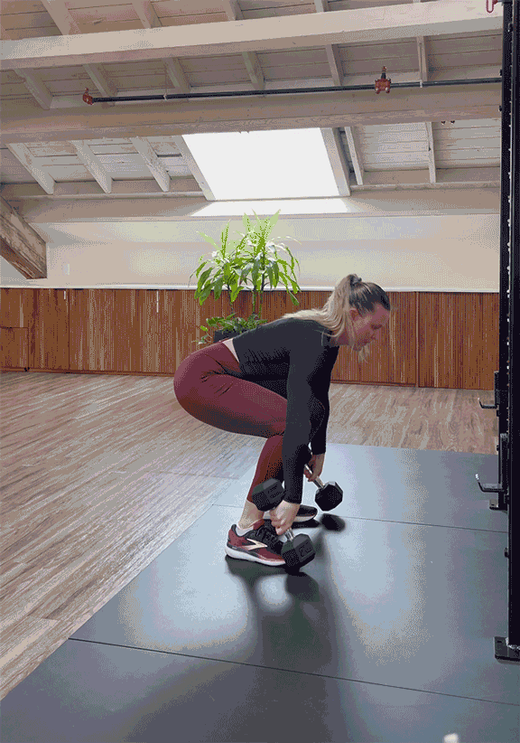 woman doing power clean with dumbbells woman doing power clean with dumbbells