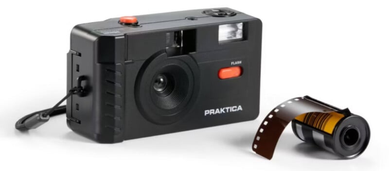 A black Praktica film camera with a wrist strap sits next to a roll of 35mm film, partially unspooled, on a white background.