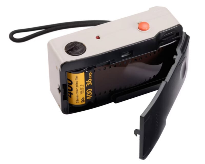 A compact film camera with its back door open, showing a partially loaded roll of Kodak Gold 35mm film labeled ISO 400, 36 exposures. The camera has a black wrist strap and orange shutter button.