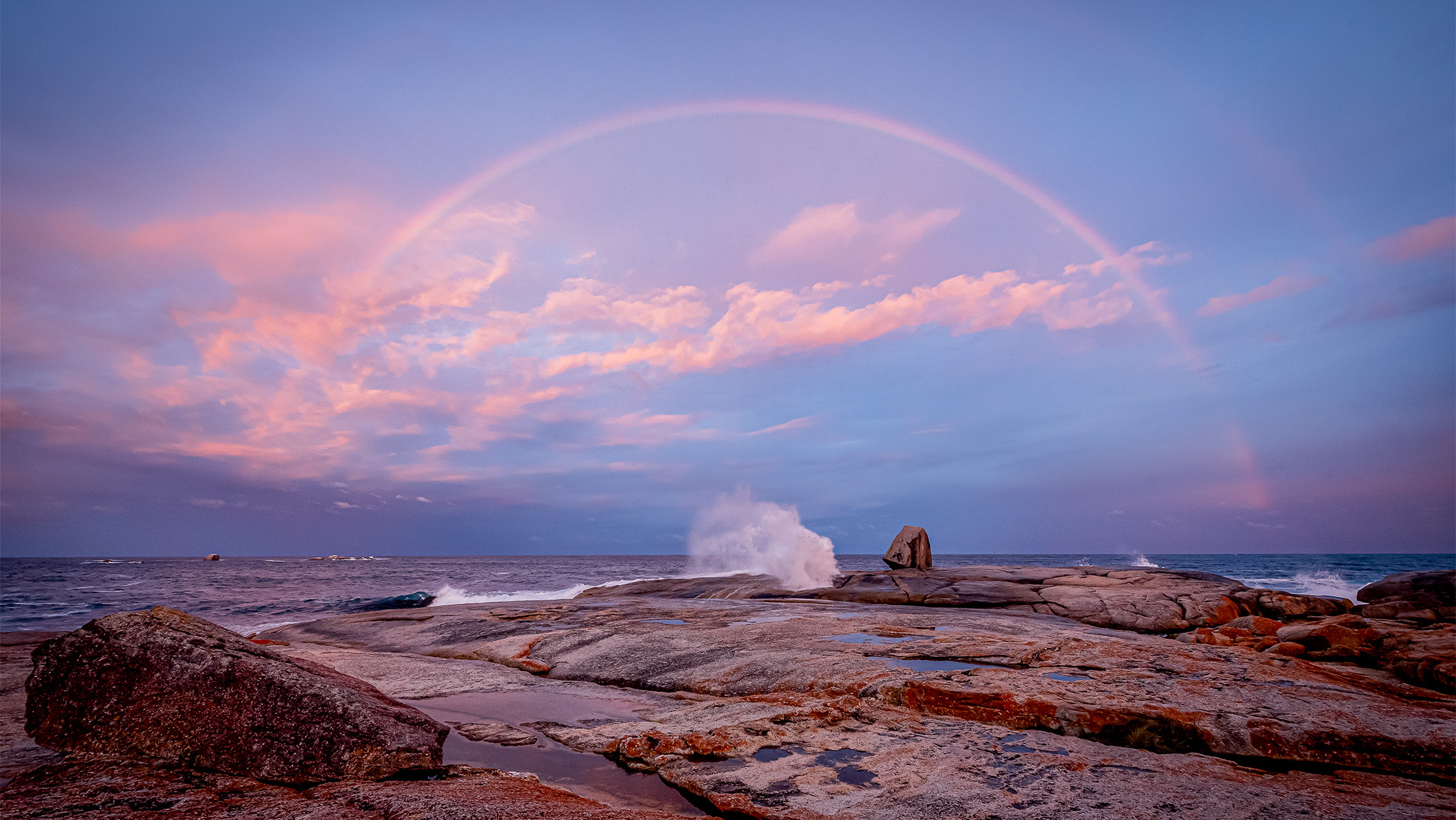 Rainbow over rock pool