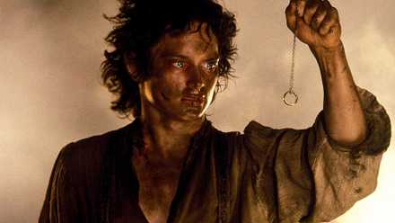 Frodo holds the ring on a chain in Lord of the Rings Return of the King