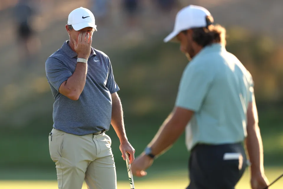 Rory McIlroy remains just about in touch after a rollercoaster second round