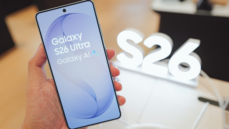 S26 held in hand at convention showing S26 branding on desk where phone was displayed