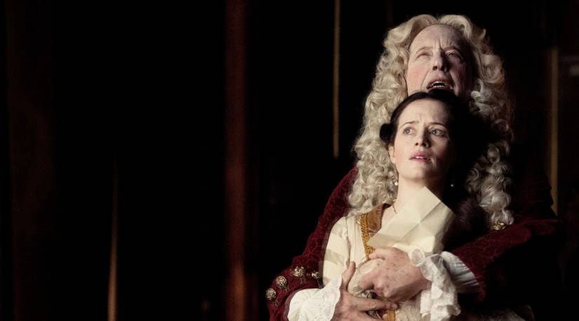 A woman and a man embrace in Savage House