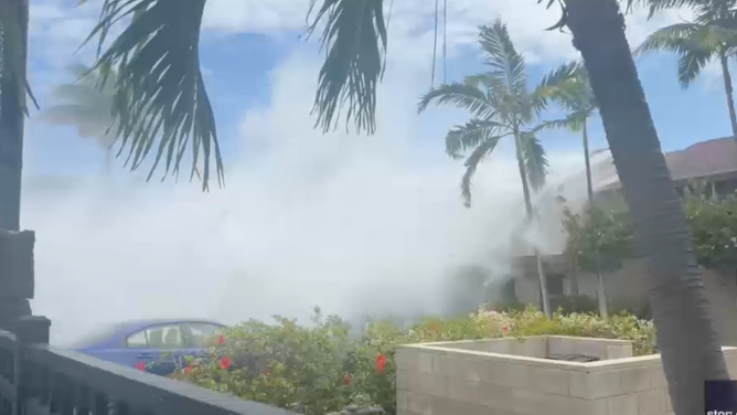 A massive wave driven by powerful south swells surges over oceanfront condos in Keauhou, Hawaii, on Sunday, June 14.