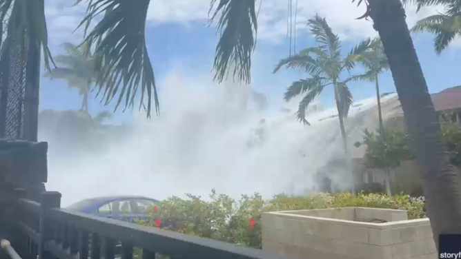 A massive wave driven by powerful south swells surges over oceanfront condos in Keauhou, Hawaii, on Sunday, June 14.