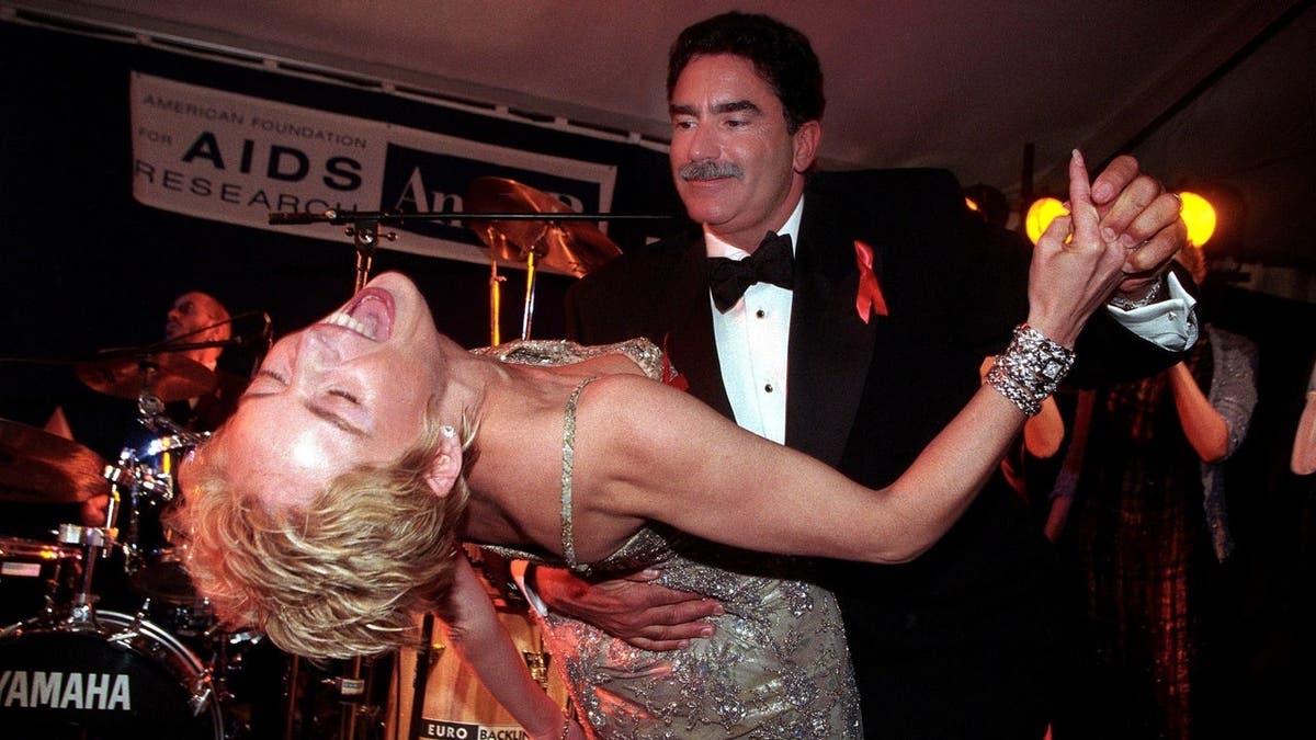 Sharon Stone and Phil Bronstein standing together at an event.