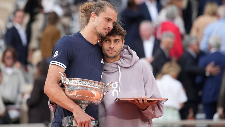 Winner Alexander Zverev of Germany, left, and second placed Flavio Cobolli of Italy hug with their trophies after the men's final match at t