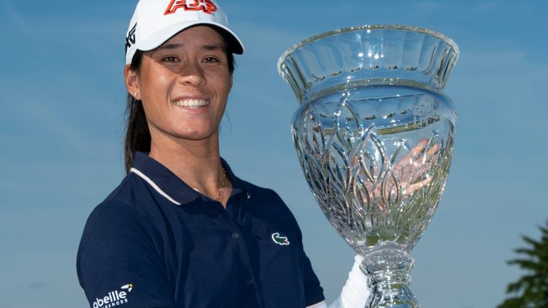 Celine Boutier holds up the trophy after winning
