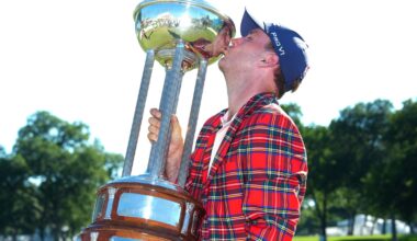 Russell Henley kisses the winner's trophy after winning the Charles Schwab Challenge in a playoff