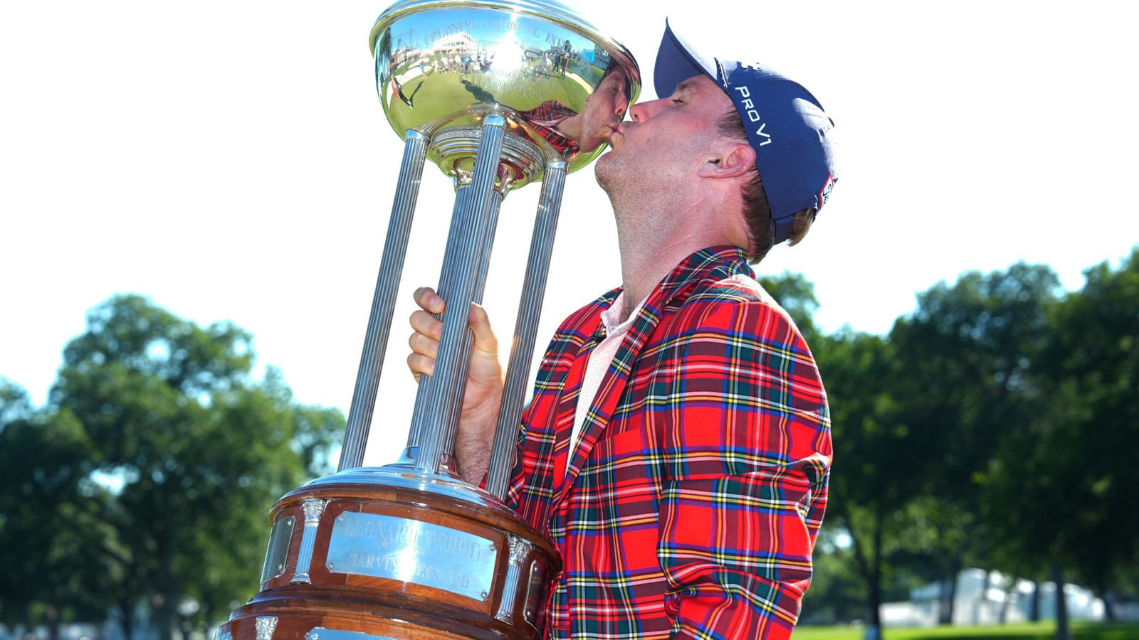 Russell Henley kisses the winner's trophy after winning the Charles Schwab Challenge in a playoff